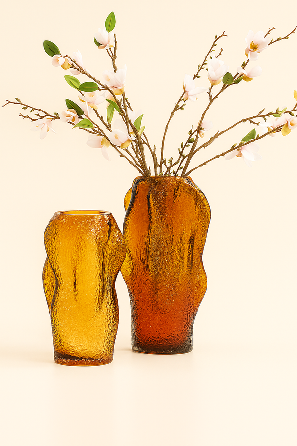 Introducing the Agnes Amber Textured Vase brought by Heritage Home Design + Living – a stunning masterpiece in luxury home decor. This uniquely textured vase boasts an abstract shape, bathed in a rich amber hue that exudes opulence. Available in one size, this beautiful piece promises to elevate your living space with its unmatched elegance, making it a timeless addition to your home.